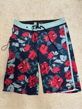 Quiksilver Navy Floral Boardshorts with Teal Waistband and Red Accents